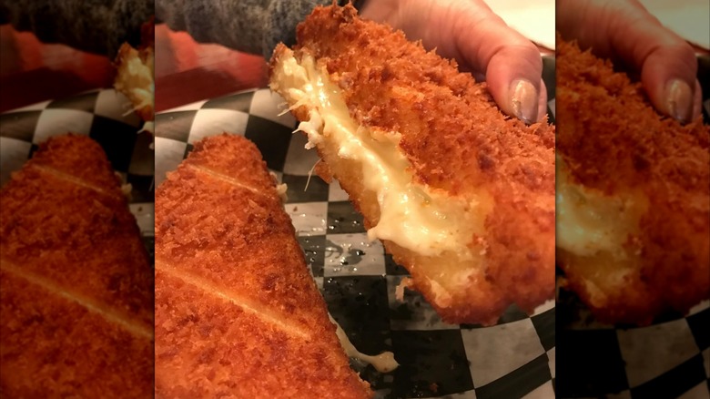 hand holding deep-fried grilled cheese