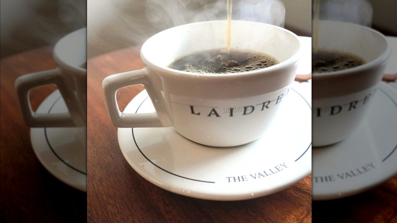 Coffee pouring into a mug with steam