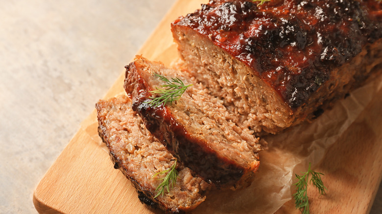 Sliced meatloaf on a wooden board