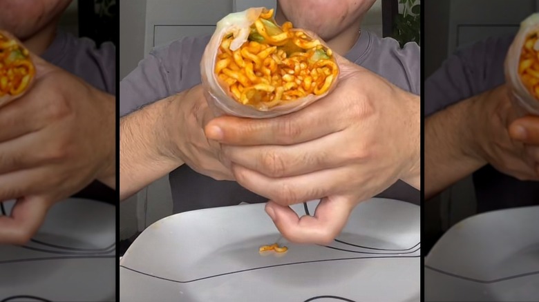 a food influencer shows off a Buldak spring roll