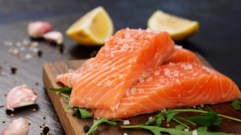 Raw salmon on cutting board