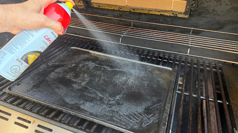Spraying griddle on grill with cooking spray