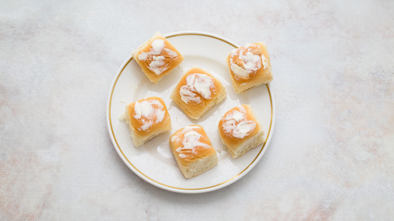 buttered buns on white plate
