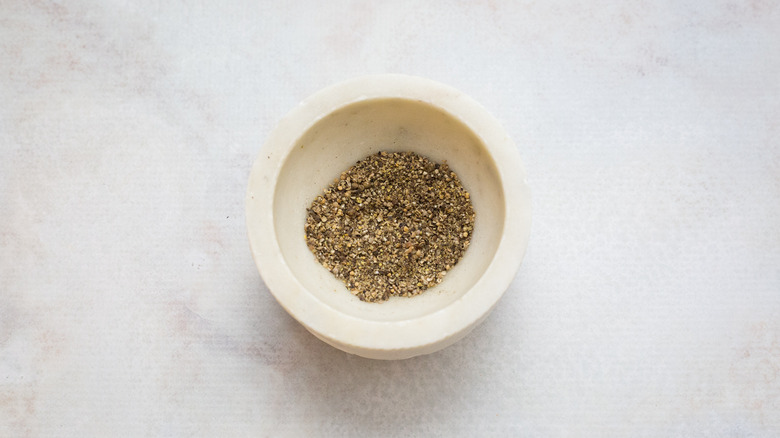 assorted spices in stone mortar
