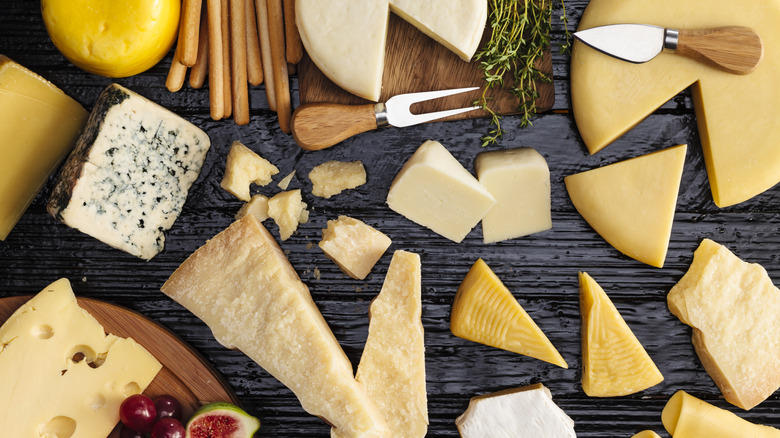 An array of cheese wedges on a black table