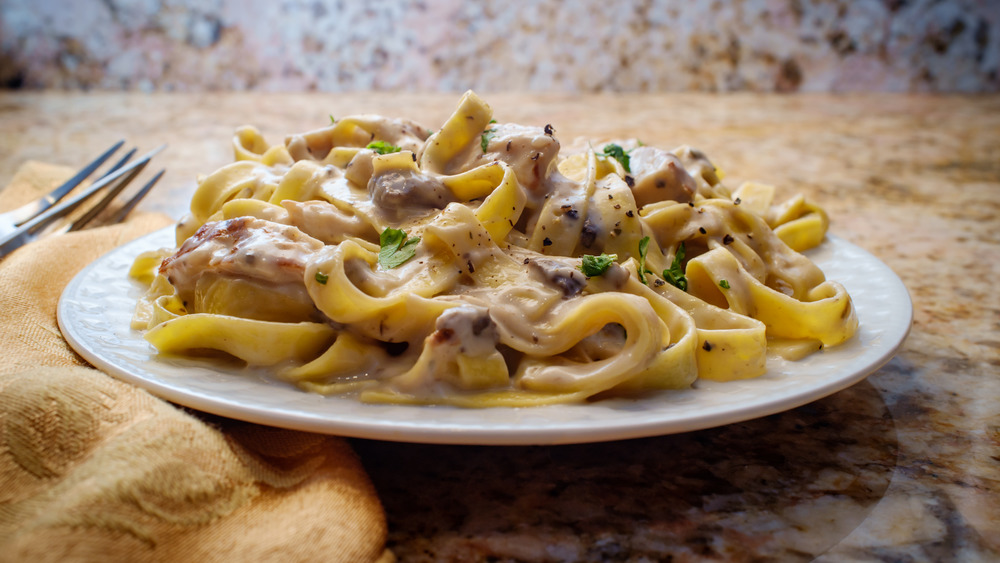 Pasta in smothered in Alfredo sauce