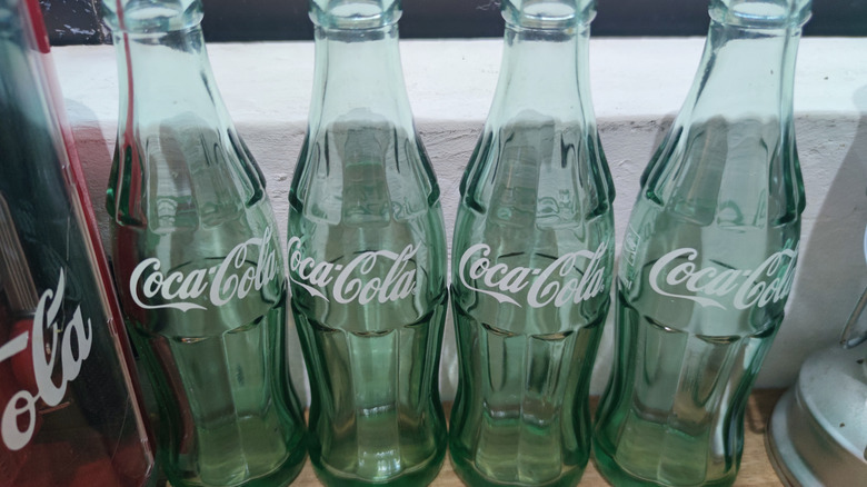 Four vintage Coke bottles