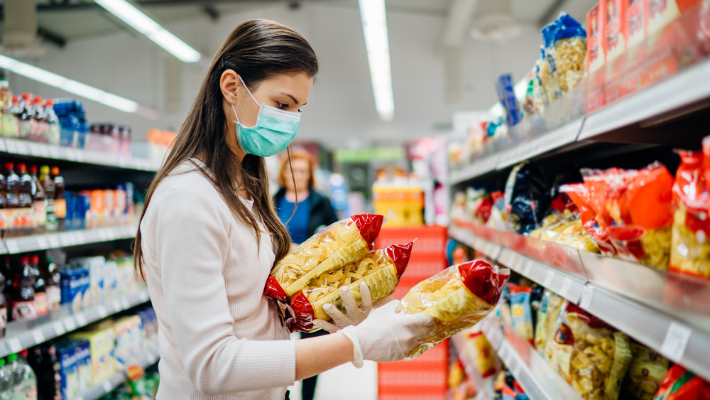 Woman evaluating food labels 