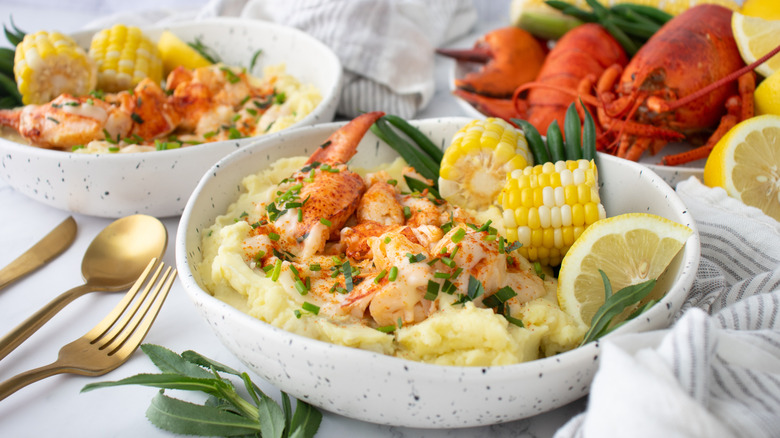 lobster mashed potatoes in bowl with beurre blanc sauce and corn