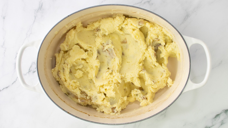 mashed potatoes in pot on marble surface