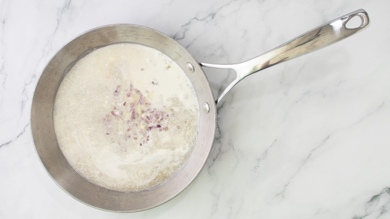 beer and cream sauce in skillet on marble surface