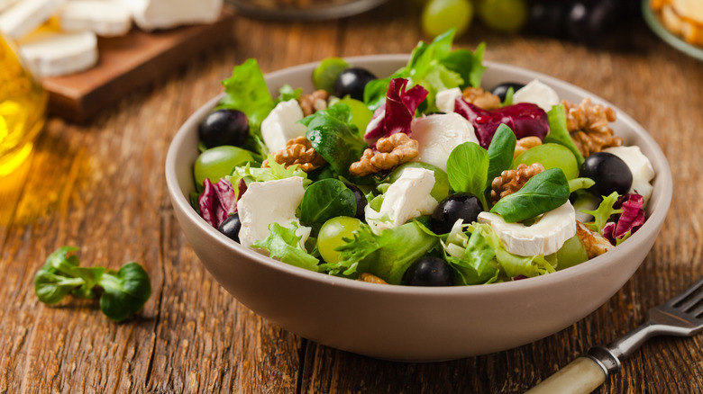 bowl of salad lettuce walnuts cheese olives