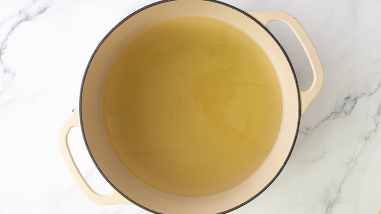 oil in large pot on marble surface