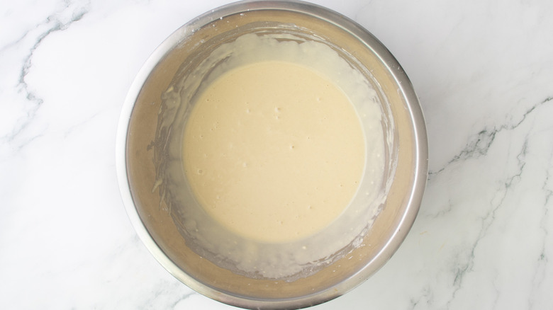 wet batter mix in bowl on marble surface