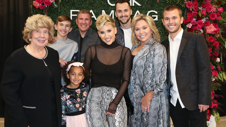 Chrisley family against floral background