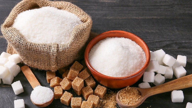 sugar in bowls with sugar cubes and spoons