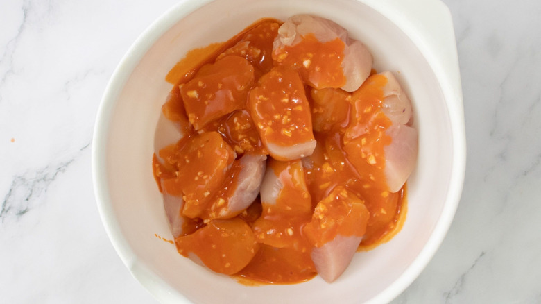 Diced chicken and Buffalo sauce in bowl