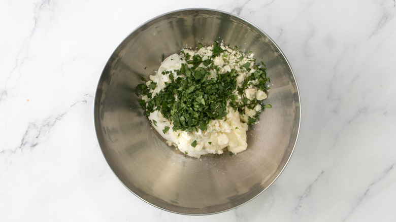Herbs and blue cheese in bowl
