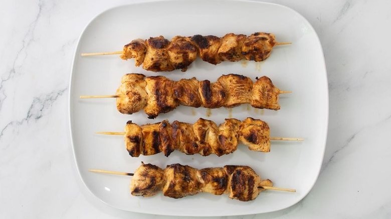 Grilled chicken skewers on plate