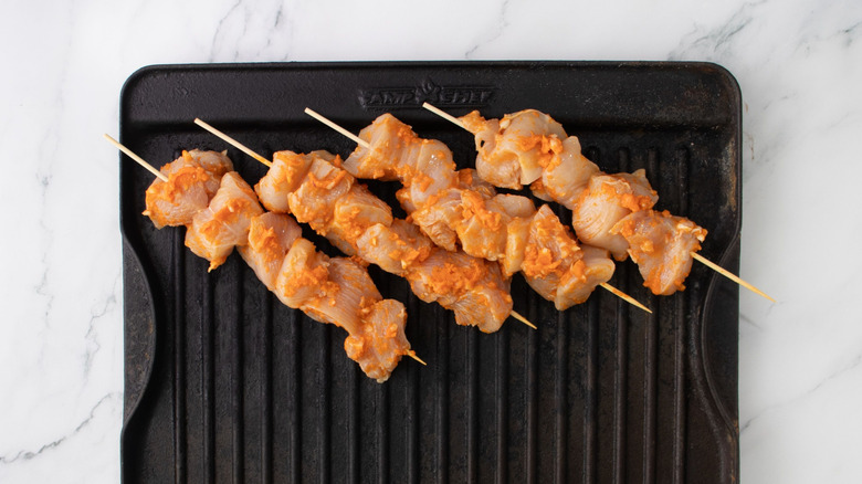 Buffalo chicken skewers on grill pan