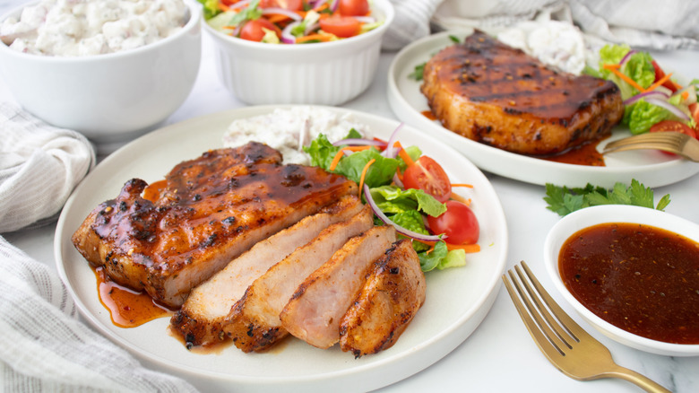 sliced pork chop with bbq sauce and salad