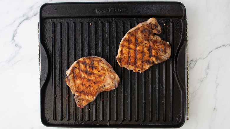 pork chops cooking on grill