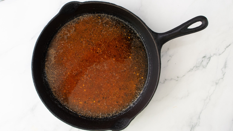 skillet with seasoning blend and melted butter