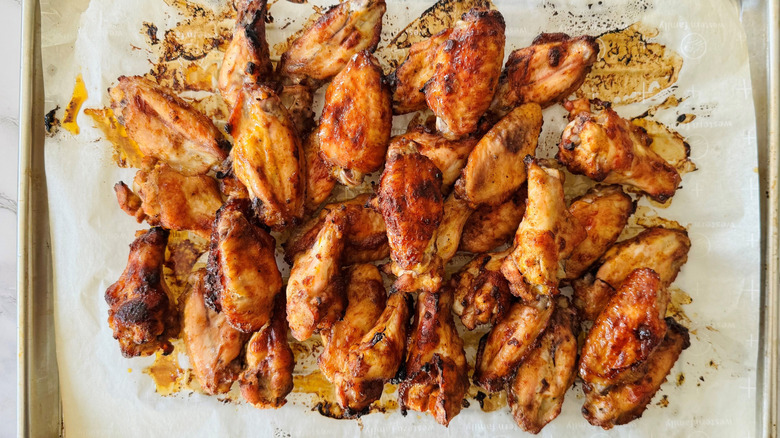 Baked chicken wings on baking sheet