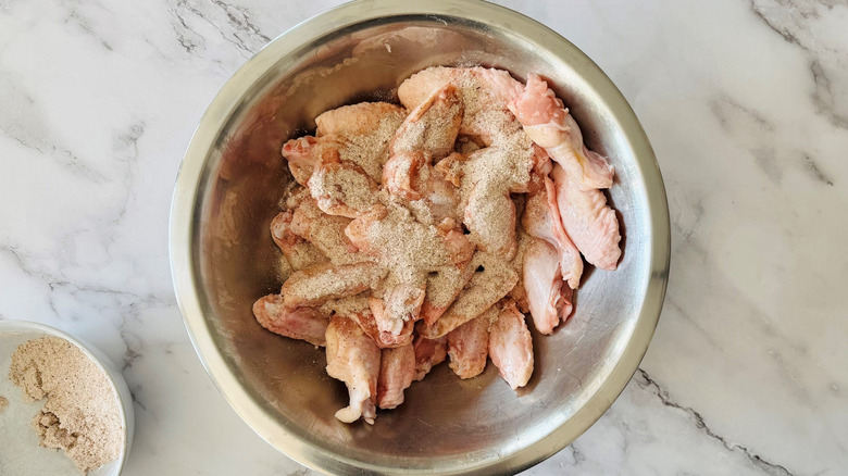 Chicken wings in bowl coated in dry rub