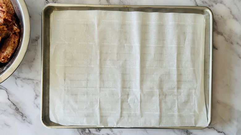 Baking sheet with wire racks and parchment paper on top