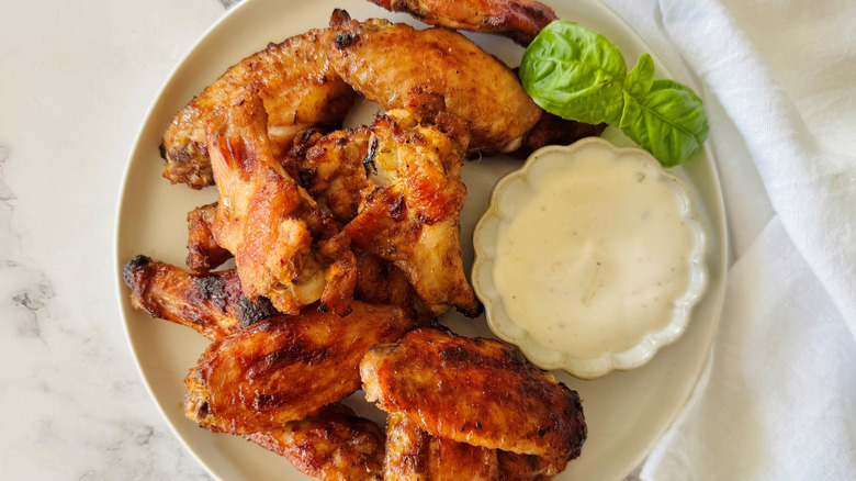 Chicken wings on plate with bowl of ranch