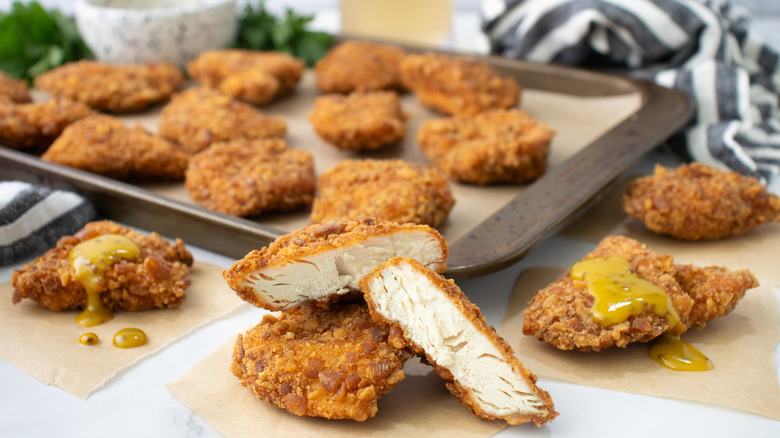 cut open chicken nugget with whole nuggets