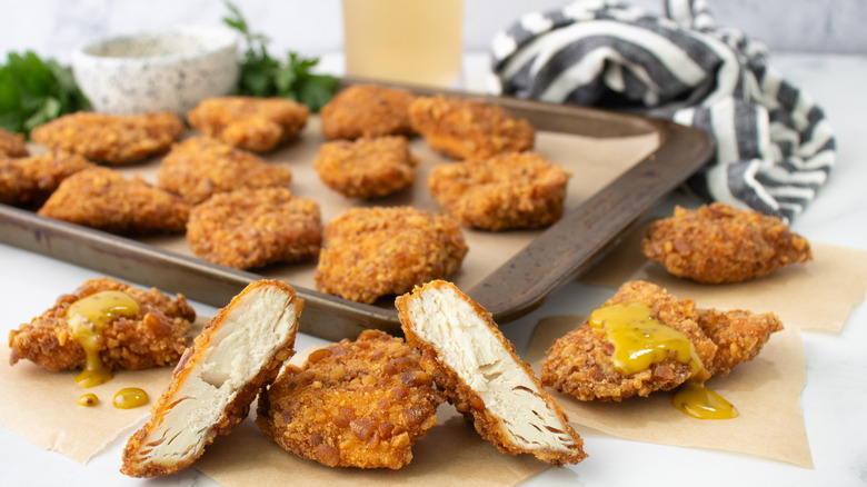 cut open chicken nugget with whole nuggets