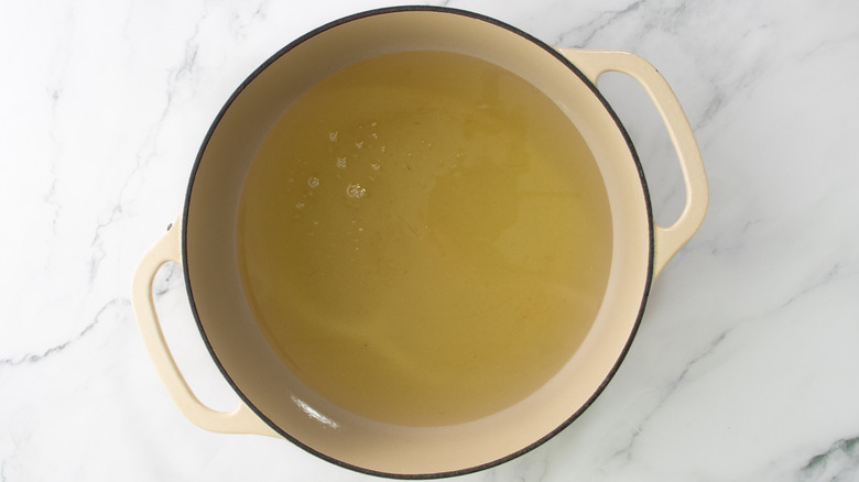 cooking oil in a beige pot