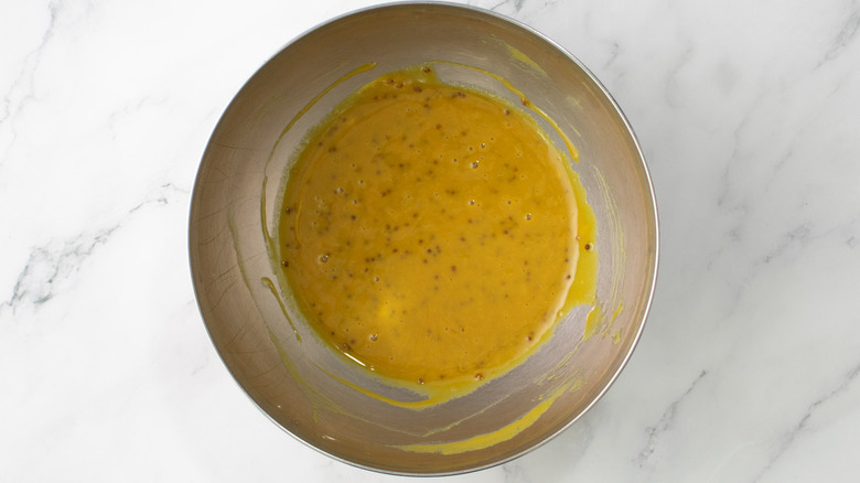 yellow sauce in a metal bowl