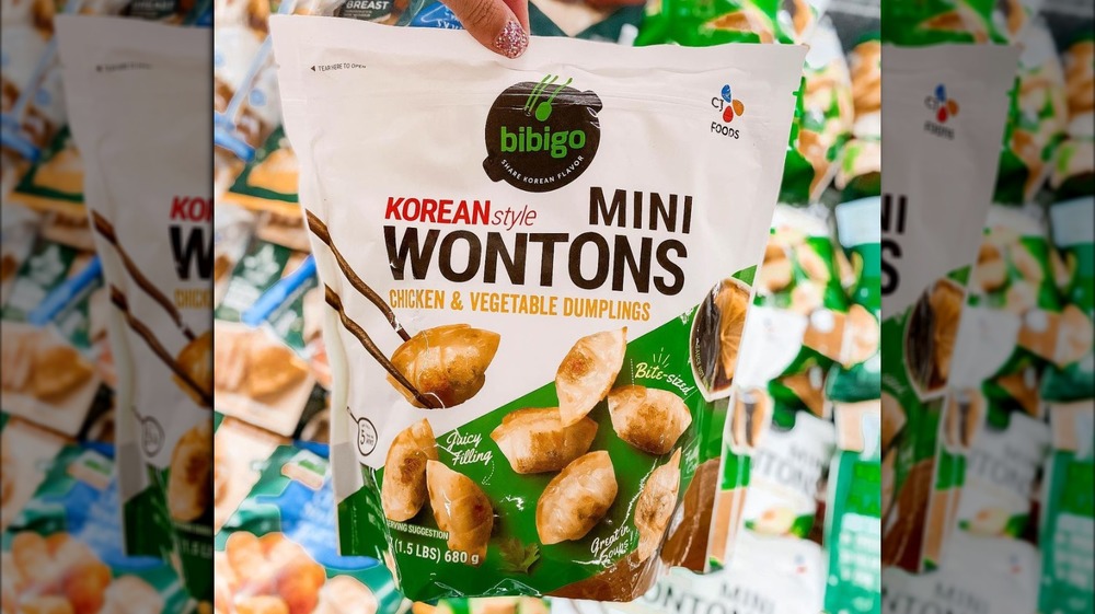 Holding Bibigo Korean-style mini wontons