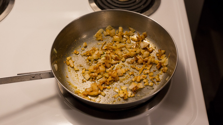 seasoned onions cooking in pan