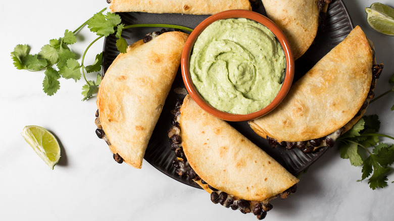 crispy tacos arranged on plate