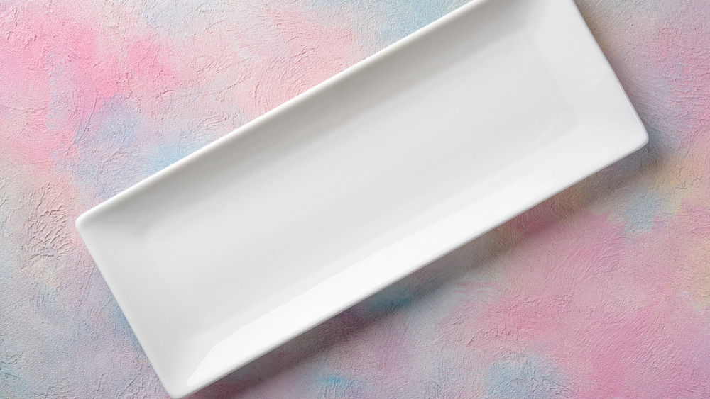 empty white serving tray on multi-color background