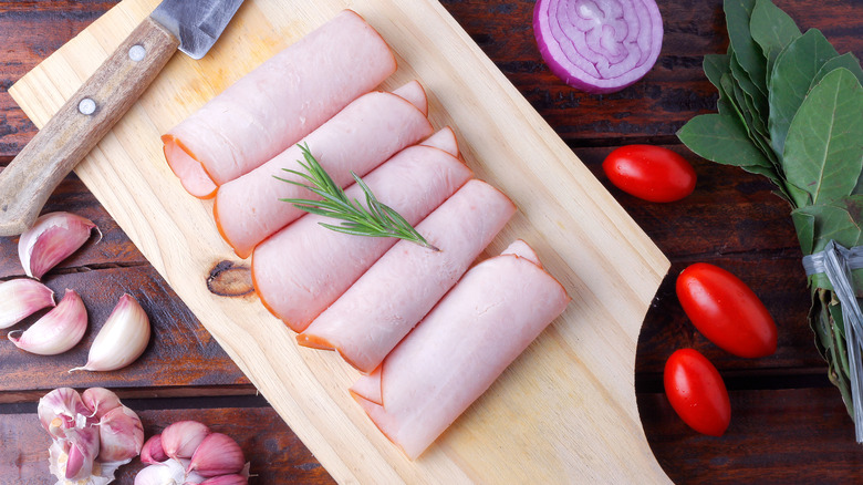 Sliced cold turkey on a cutting board