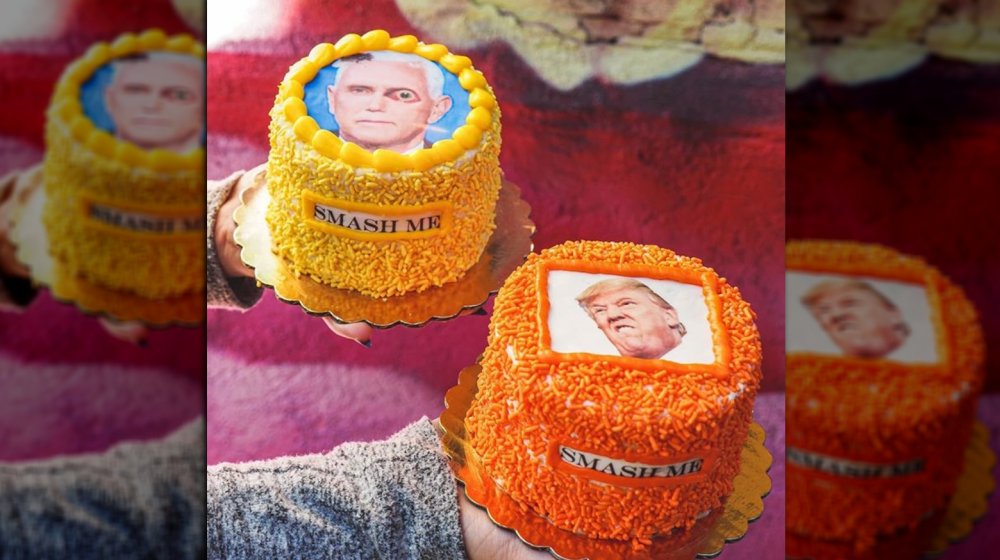 Colorful cakes topped with images of Pence and Trump, with words "smash me" written on side