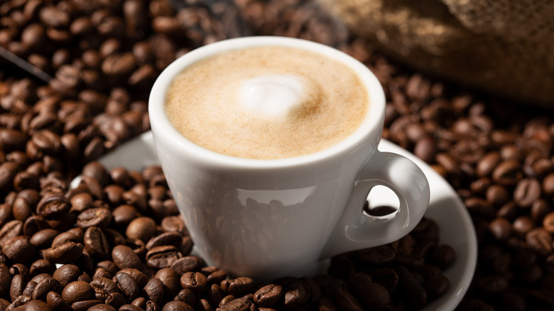 Coffee mug on a bed of coffee beans