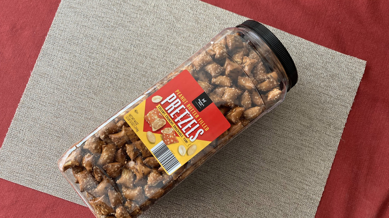 Canister of Member's Mark peanut butter-filled pretzels on placemat.