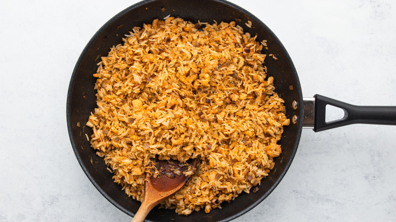 Rice and seafood cooking in frying pan