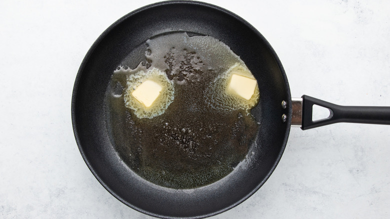 Butter melting in frying pan