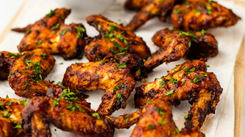 Barbecue chicken wings garnished with chopped parsley