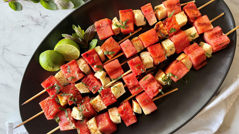 Grilled watermelon and halloumi skewers on serving plate