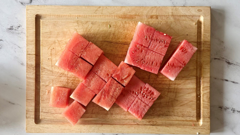 Cubed watermelon on wooden board