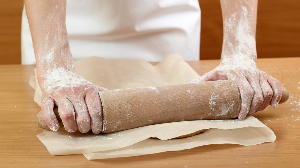 Baker rolling out dough