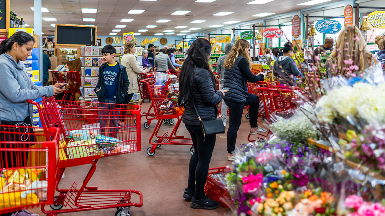 People waiting in long checkout lines at Trader Joe's